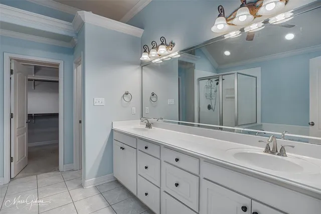 a bathroom with a double vanity sink and a mirror
