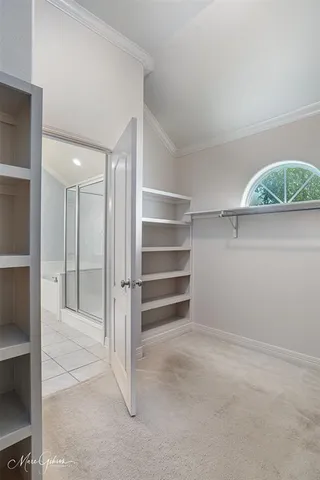 a view of a room with a walk in closet and living room