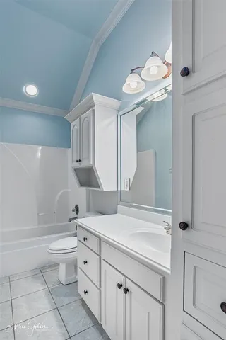 a bathroom with a granite countertop sink a toilet and bathtub