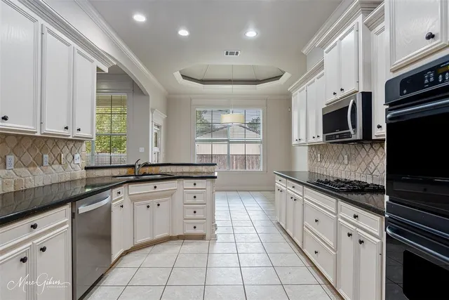 a kitchen with stainless steel appliances granite countertop a stove and a sink