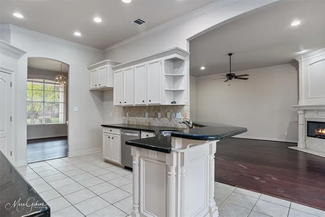 a kitchen with granite countertop a sink and a stove