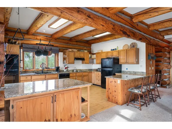 a dining room with furniture and a floor to ceiling window
