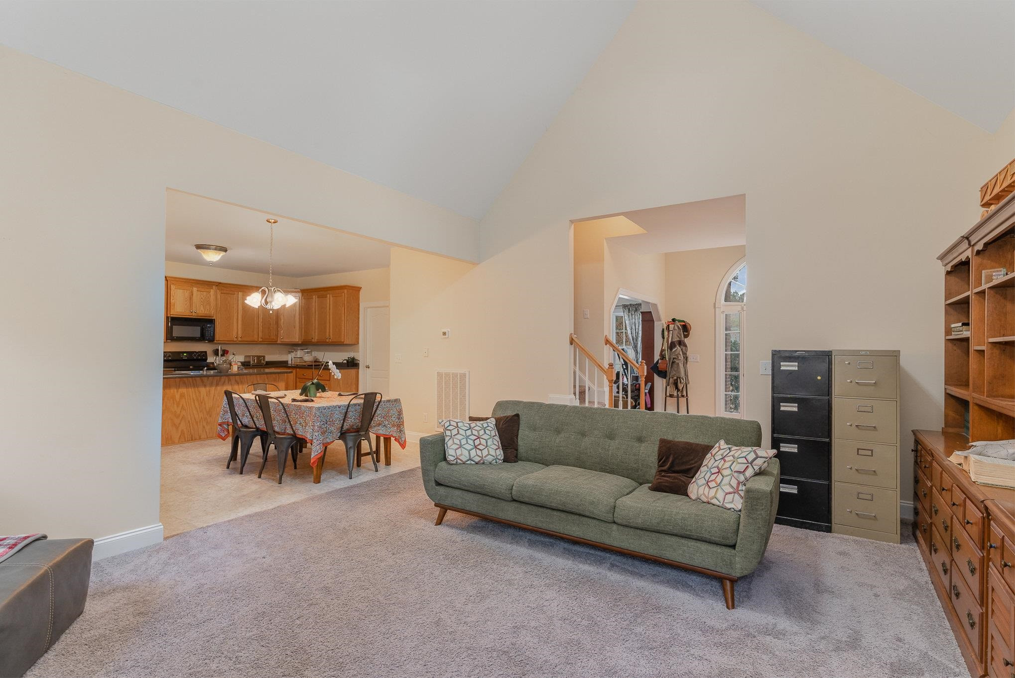 33 Alfred Court Raleigh, NC 27603 - Photo 3 of 24 a living room with furniture and a kitchen view