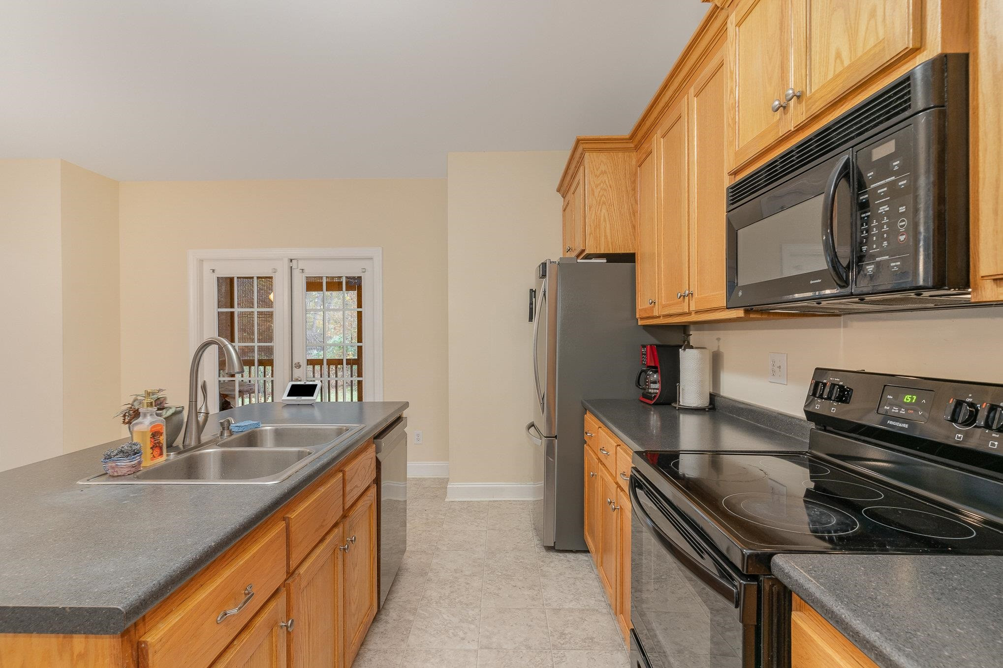 33 Alfred Court Raleigh, NC 27603 - Photo 5 of 24 a kitchen with stainless steel appliances granite countertop a sink stove and refrigerator
