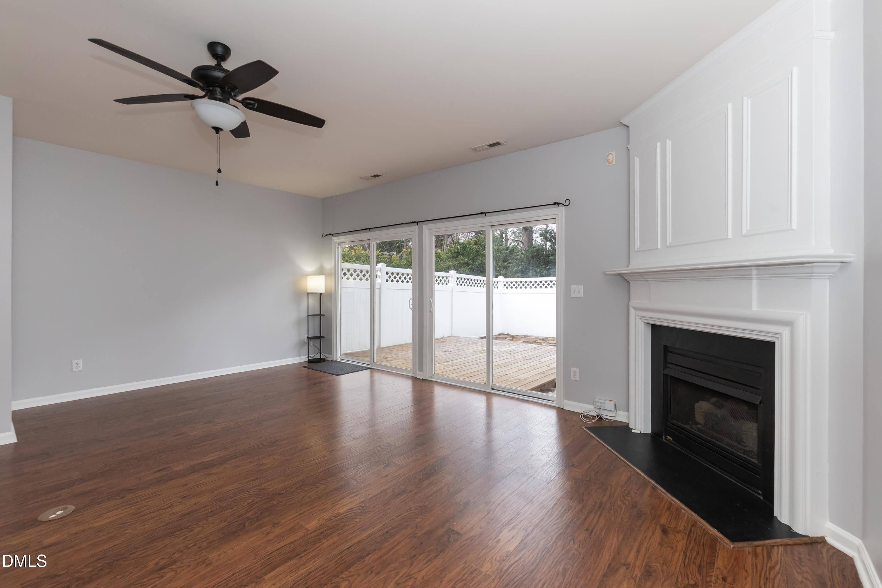 5141 TwelvePole Drive Raleigh, NC 27616 - Photo 11 of 40 a view of empty room with wooden floor and fireplace