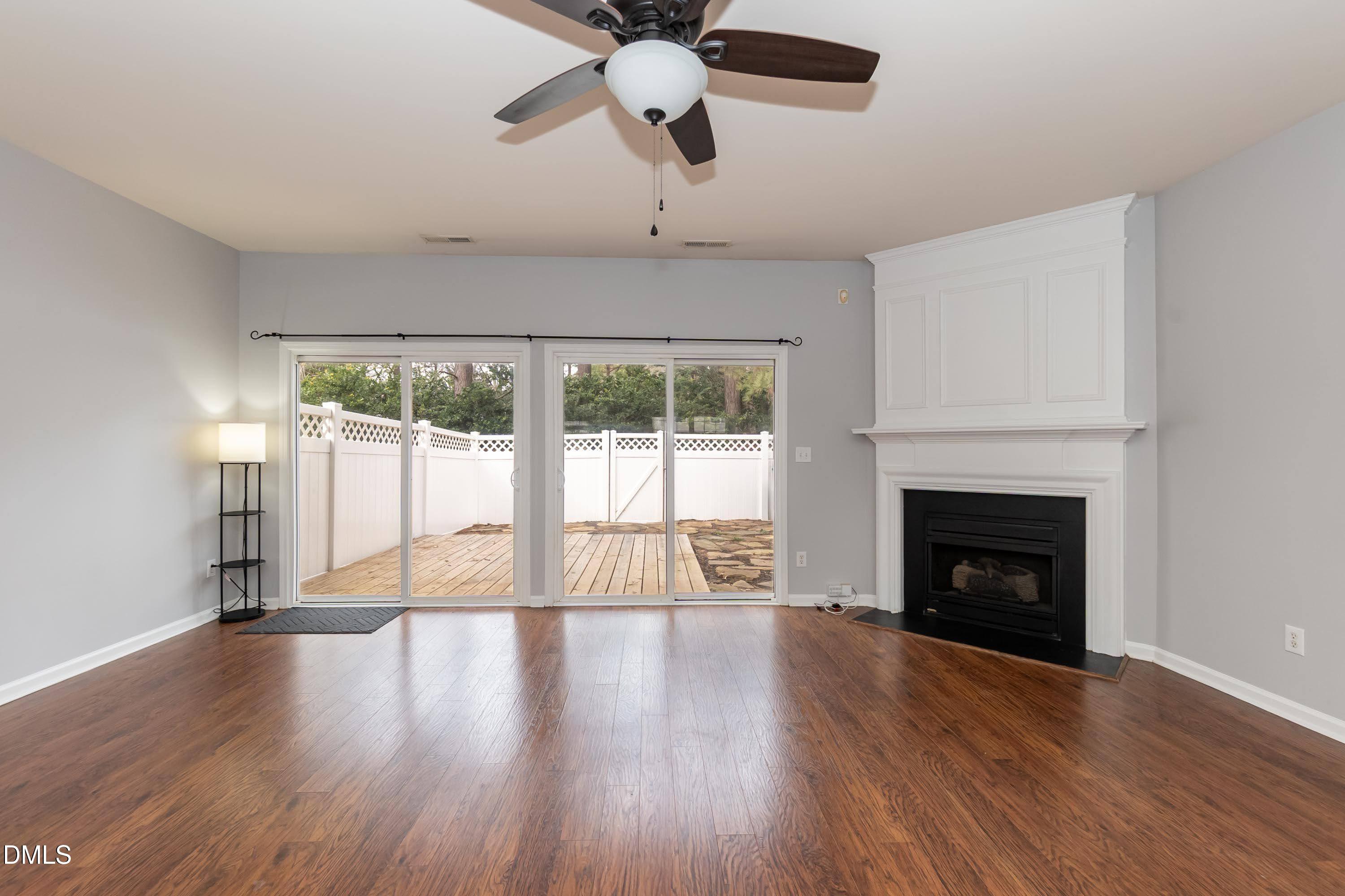 5141 TwelvePole Drive Raleigh, NC 27616 - Photo 12 of 40 a view of an empty room with wooden floor fireplace and a window