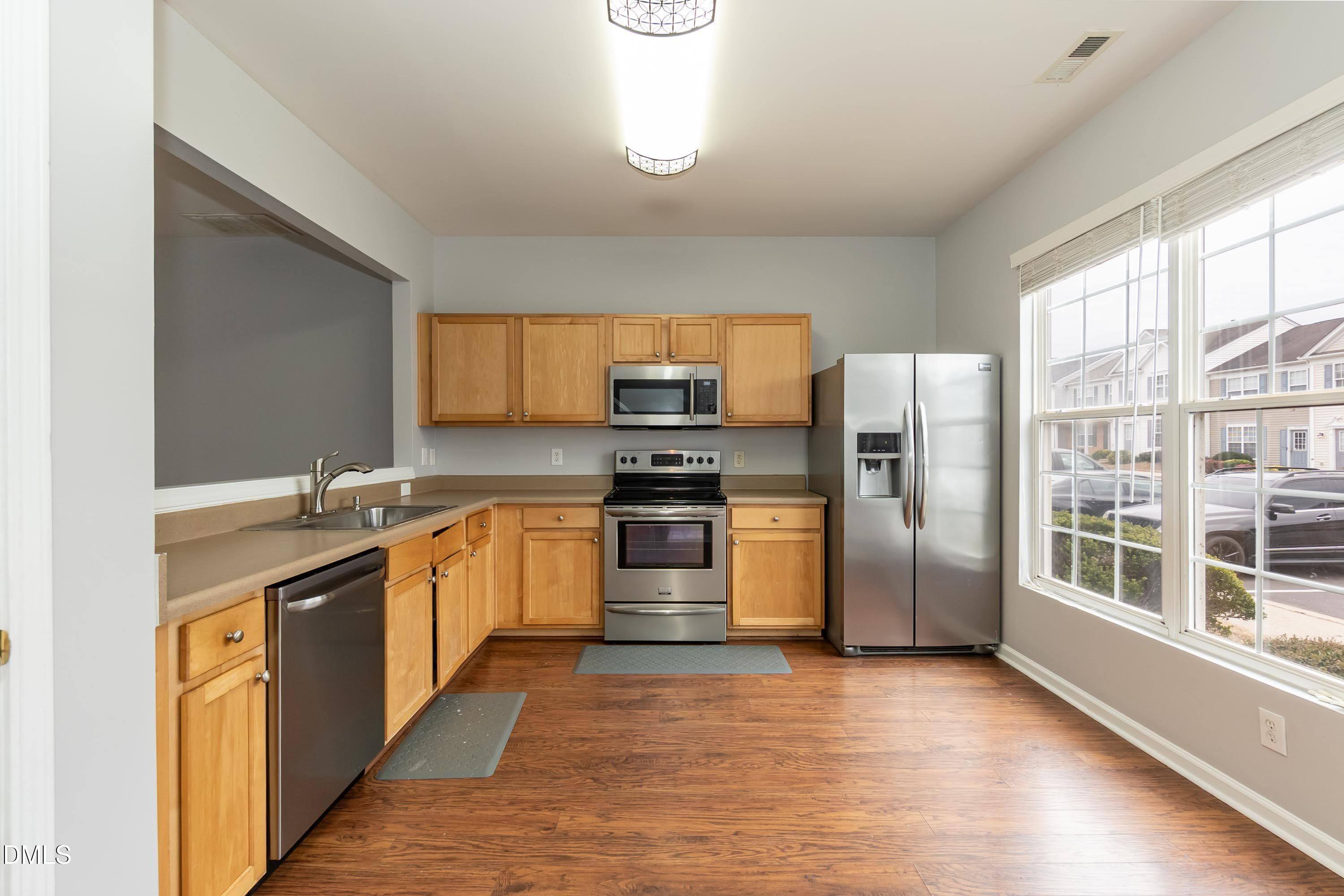 5141 TwelvePole Drive Raleigh, NC 27616 - Photo 16 of 40 a kitchen with stainless steel appliances granite countertop a refrigerator and a stove top oven