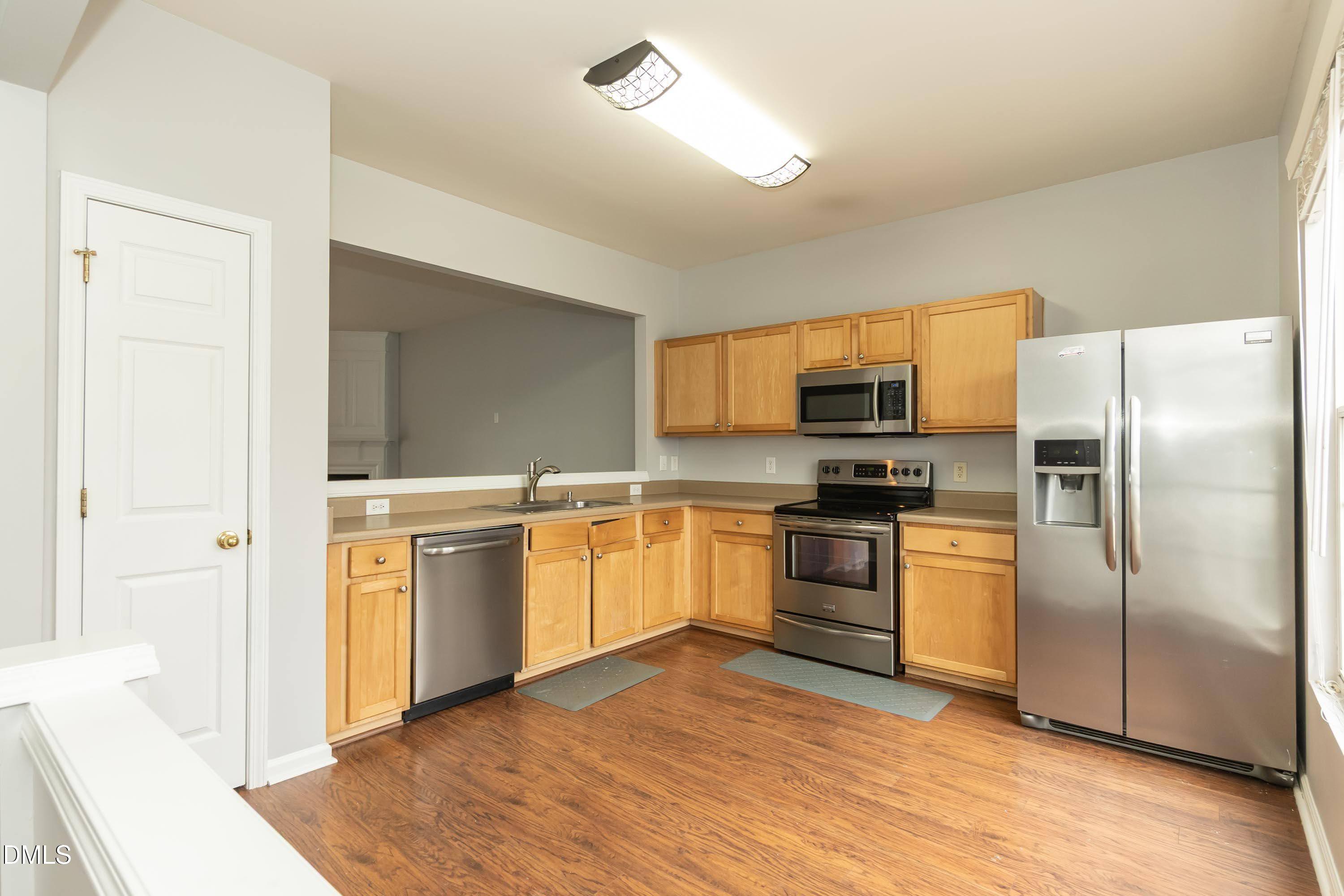5141 TwelvePole Drive Raleigh, NC 27616 - Photo 17 of 40 a kitchen with stainless steel appliances granite countertop a refrigerator and a stove top oven