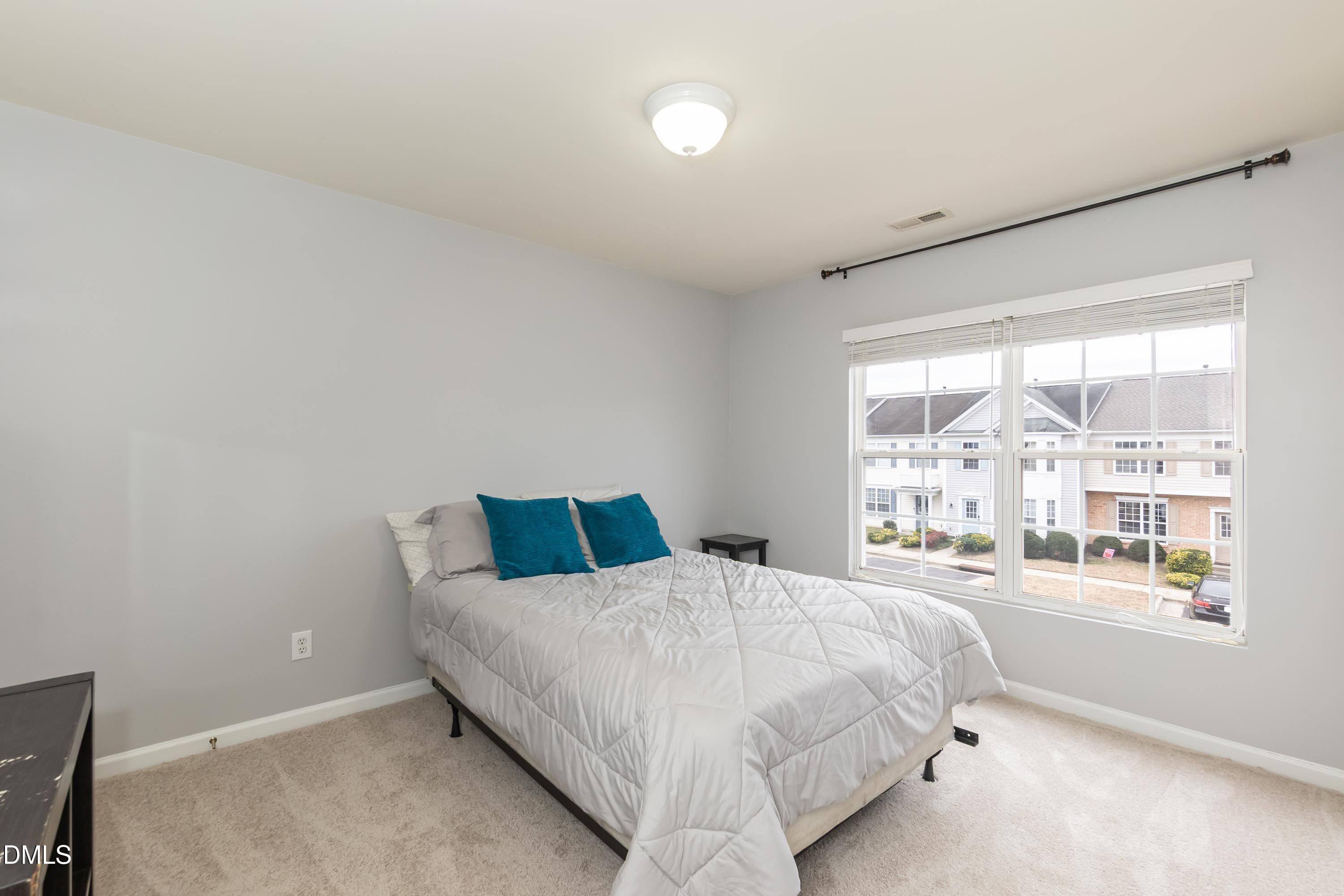 5141 TwelvePole Drive Raleigh, NC 27616 - Photo 23 of 40 a bedroom with a bed and a large window