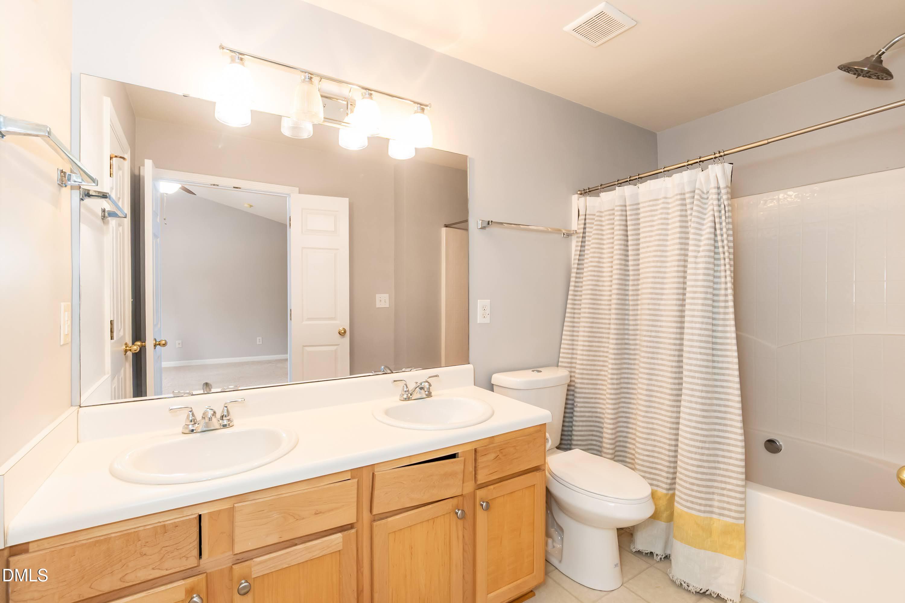 5141 TwelvePole Drive Raleigh, NC 27616 - Photo 27 of 40 a bathroom with a double vanity sink toilet and shower