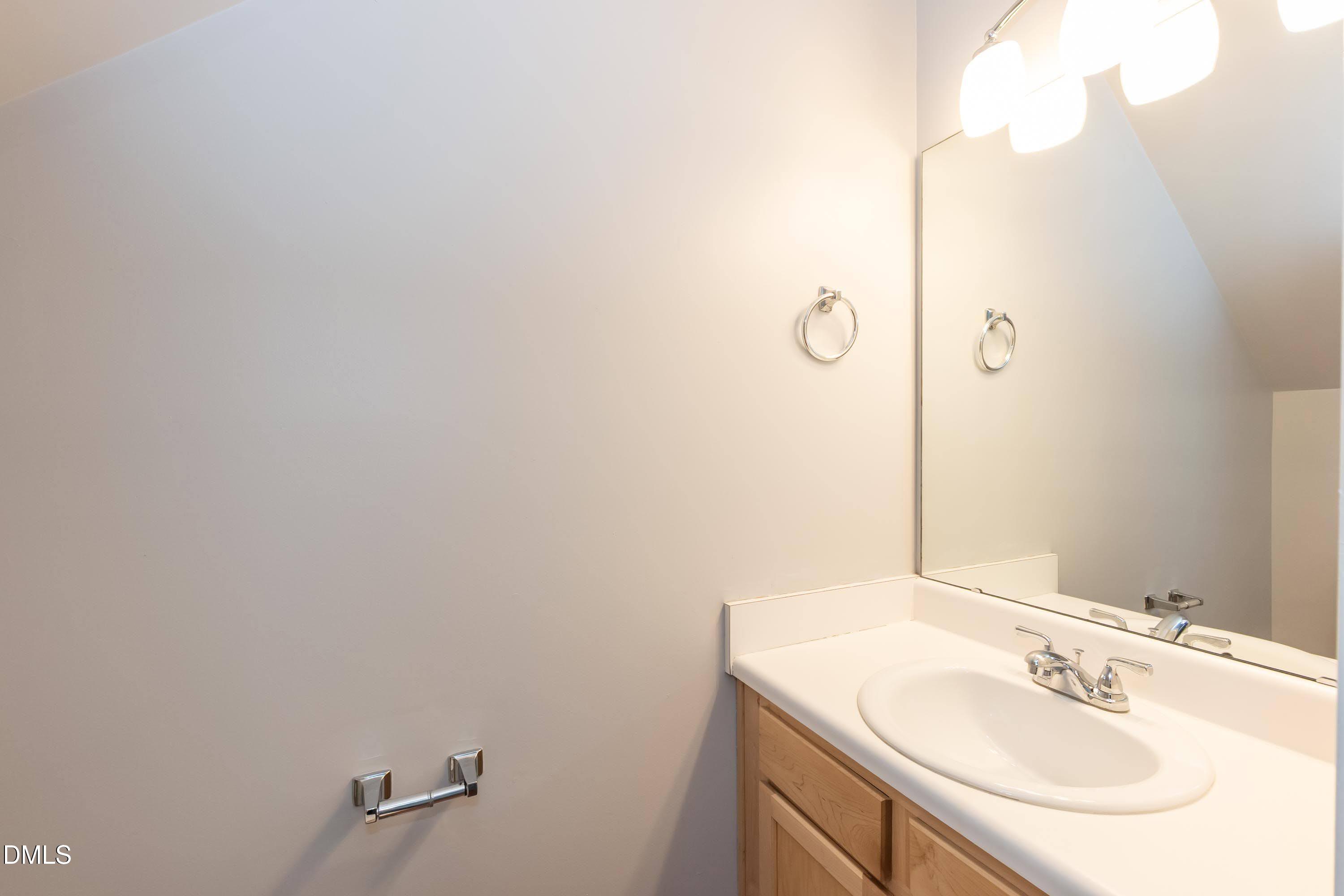 5141 TwelvePole Drive Raleigh, NC 27616 - Photo 30 of 40 a bathroom with a sink and a mirror