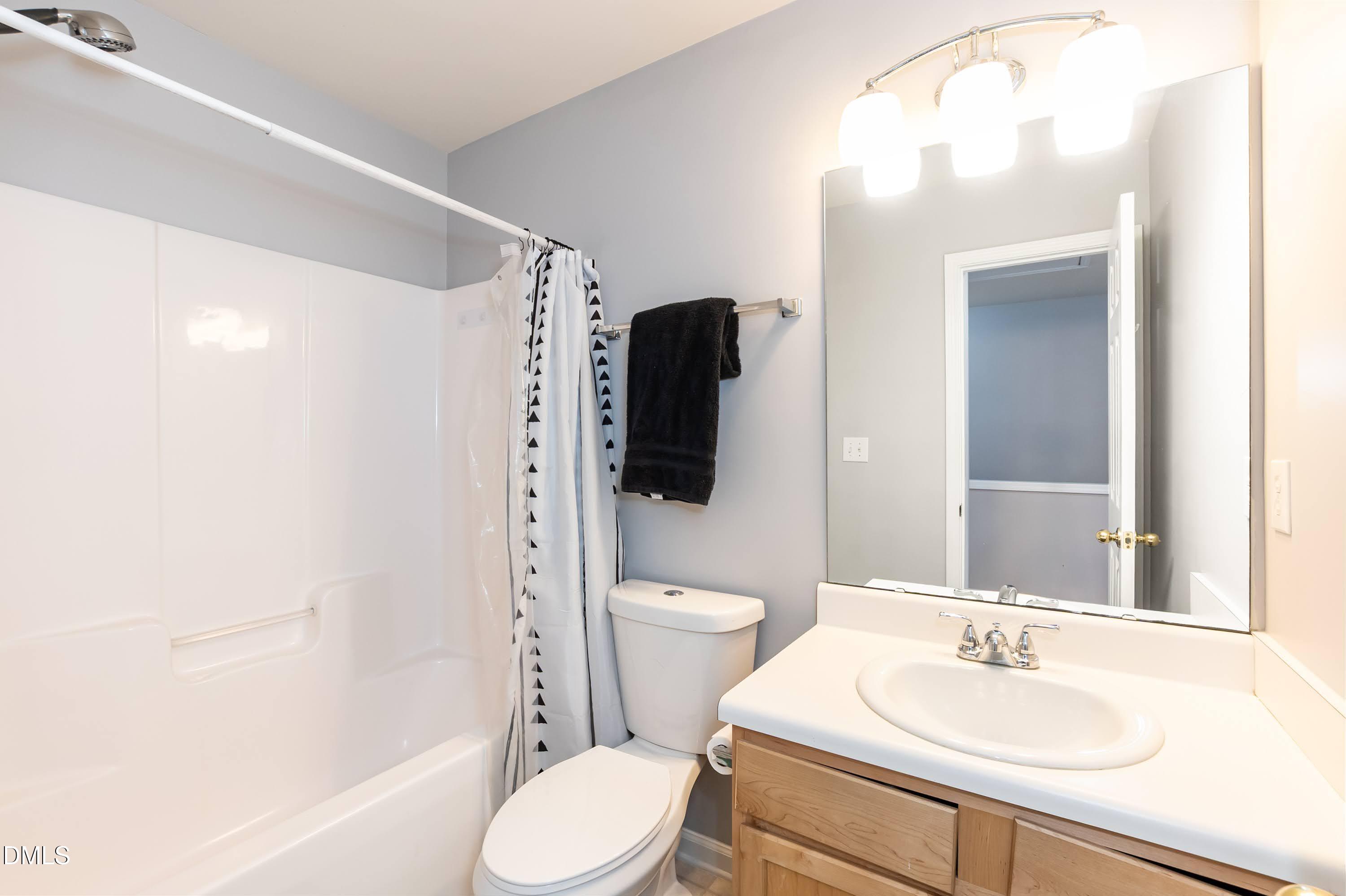 5141 TwelvePole Drive Raleigh, NC 27616 - Photo 31 of 40 a bathroom with a sink a toilet and shower