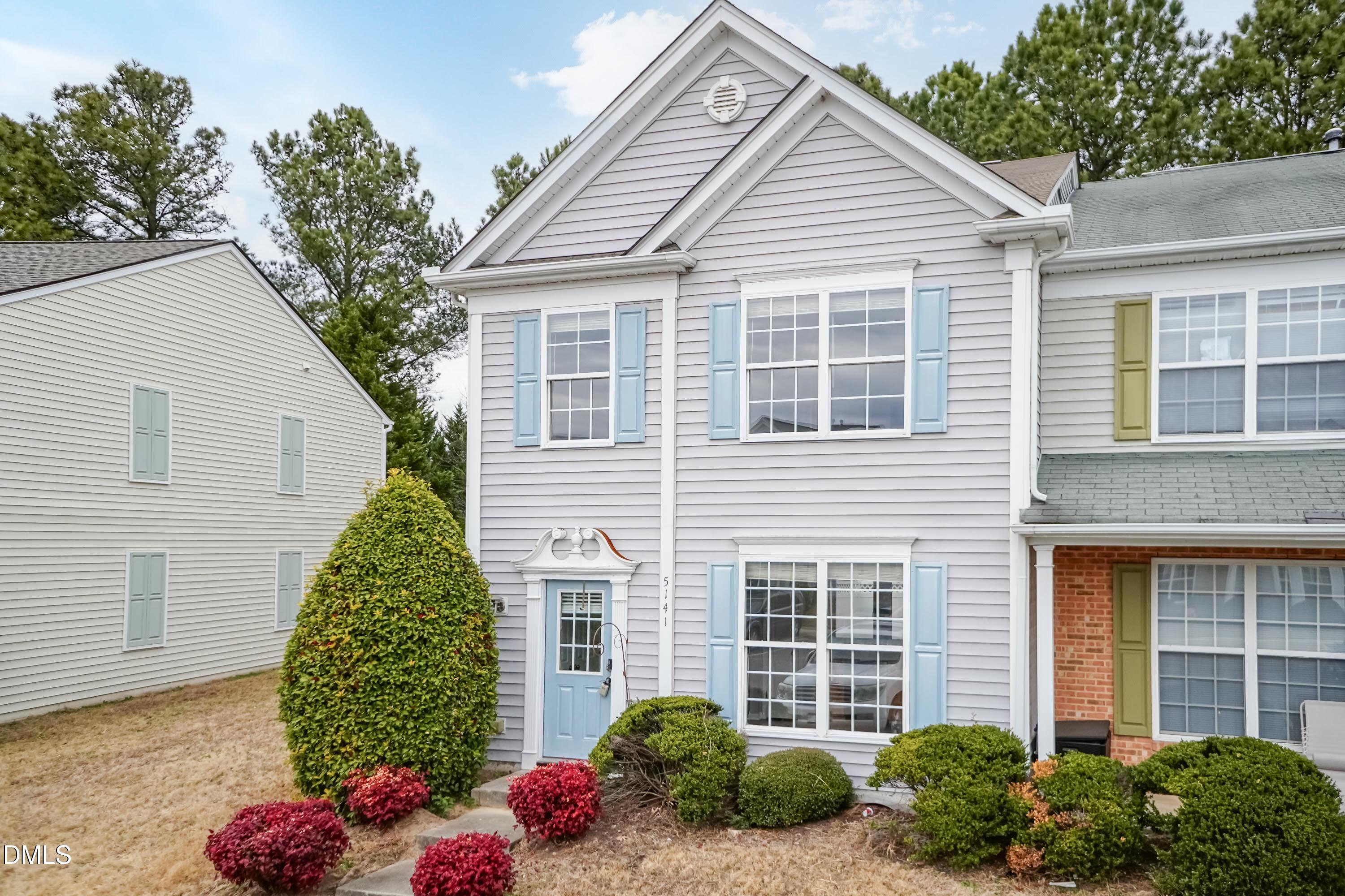 5141 TwelvePole Drive Raleigh, NC 27616 - Photo 5 of 40 a front view of a house with lots of flowers