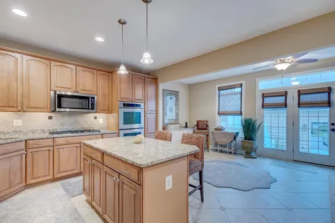 a kitchen with granite countertop a sink counter top space appliances and cabinets