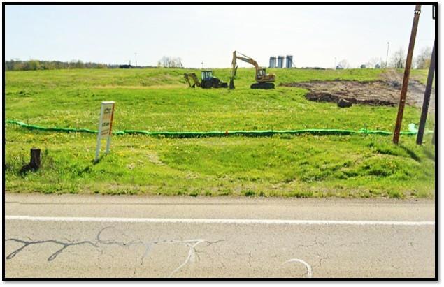a view of a yard with an ocean view