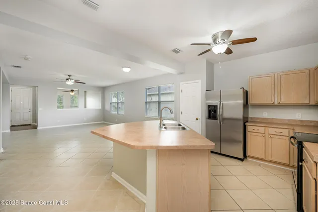 a kitchen with stainless steel appliances granite countertop a sink a stove and a refrigerator