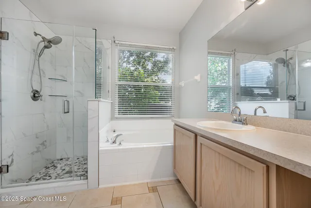 a bathroom with a tub sink and mirror