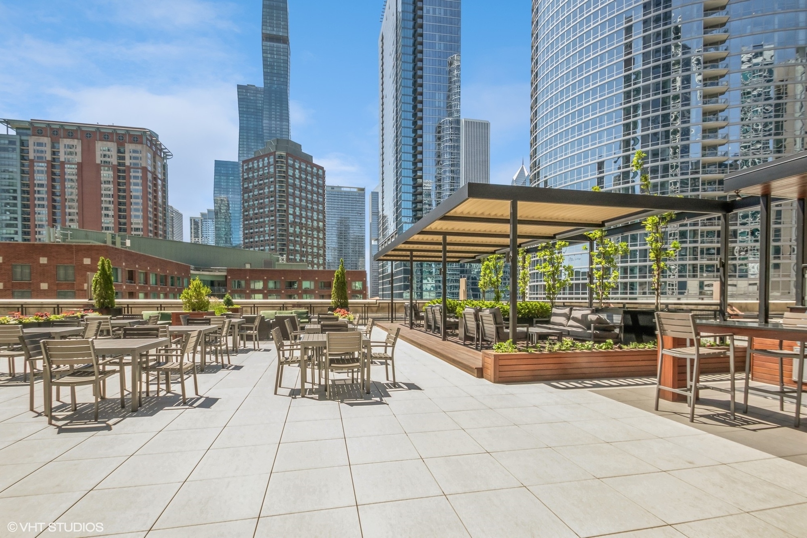 Undisclosed Address Chicago, IL 60611 - Photo 14 of 15 a patio with a table and chairs under an umbrella