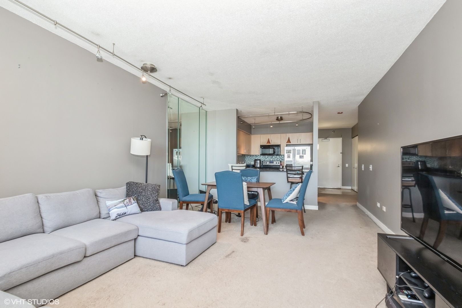 Undisclosed Address Chicago, IL 60611 - Photo 3 of 15 a living room with furniture a flat screen tv and a table