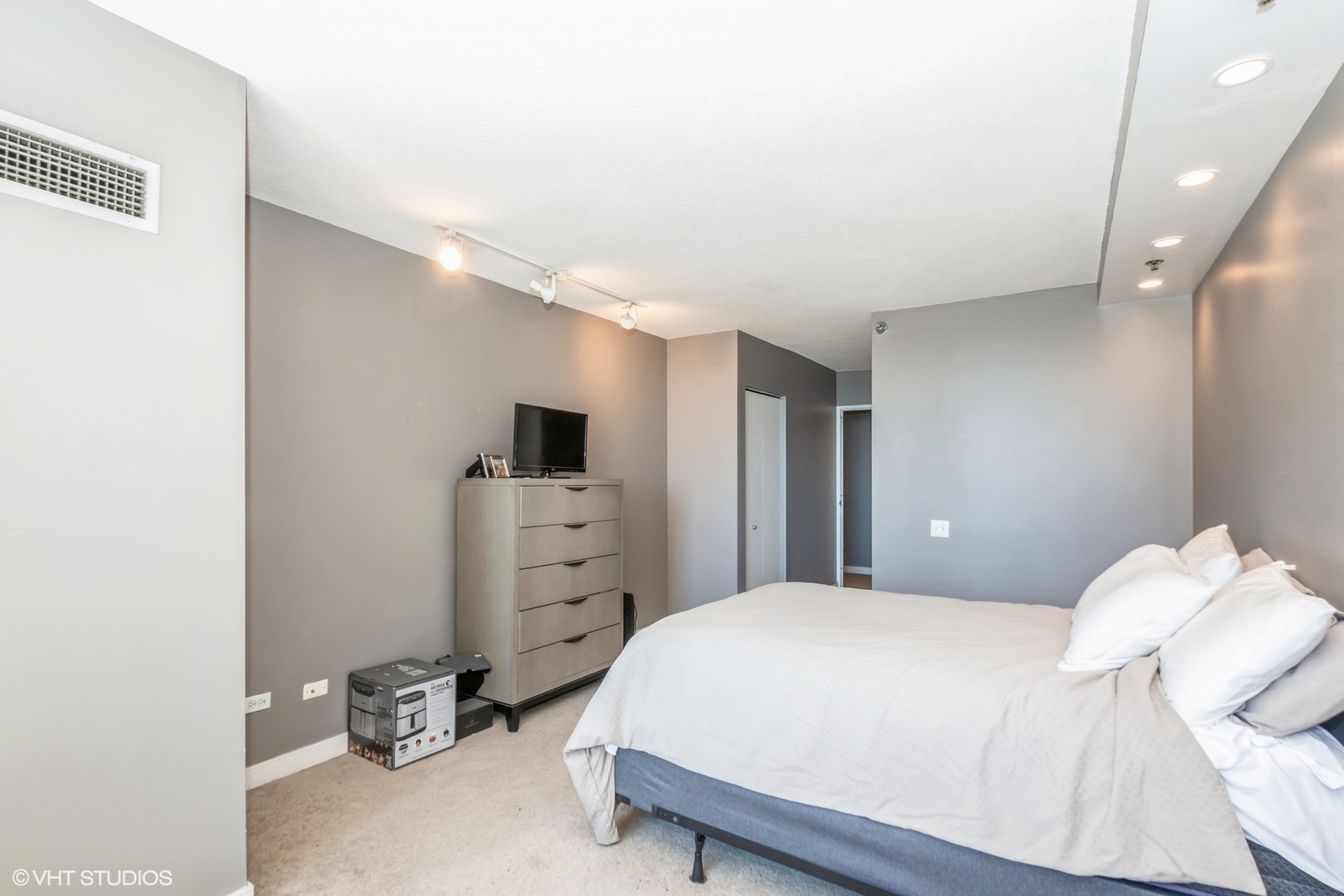 Undisclosed Address Chicago, IL 60611 - Photo 8 of 15 a bedroom with a bed and cabinets