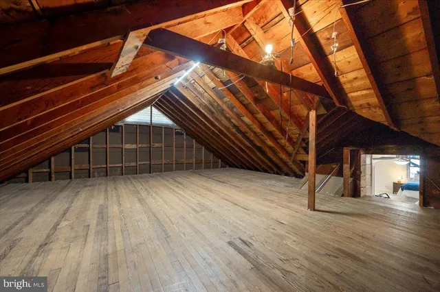an aerial view of a house with swimming pool and a yard
