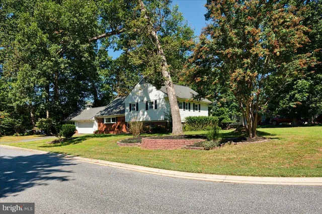 a front view of a house with a yard garage and outdoor seating
