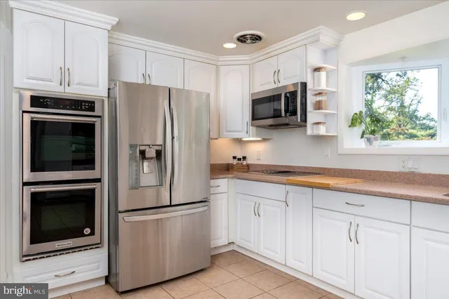 a living room with dining room furniture and wooden floor