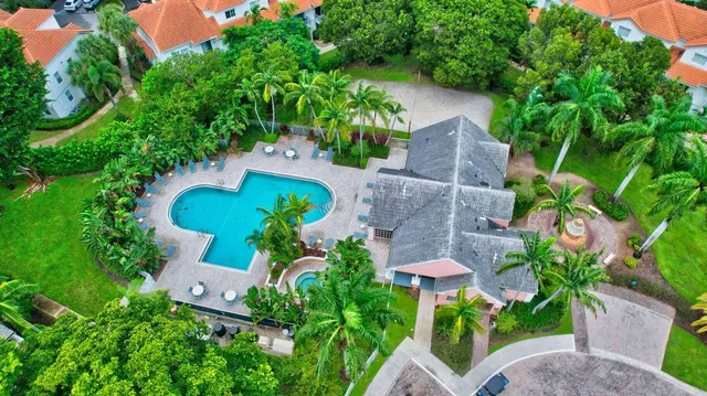 an aerial view of a house with a yard and a garden