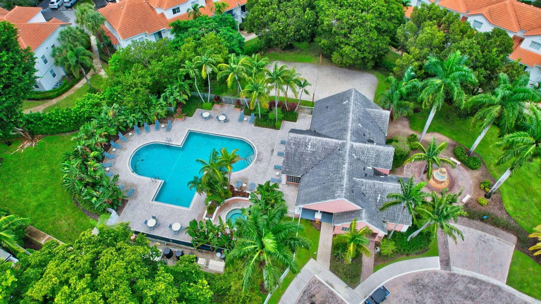 an aerial view of a house with a yard and a garden