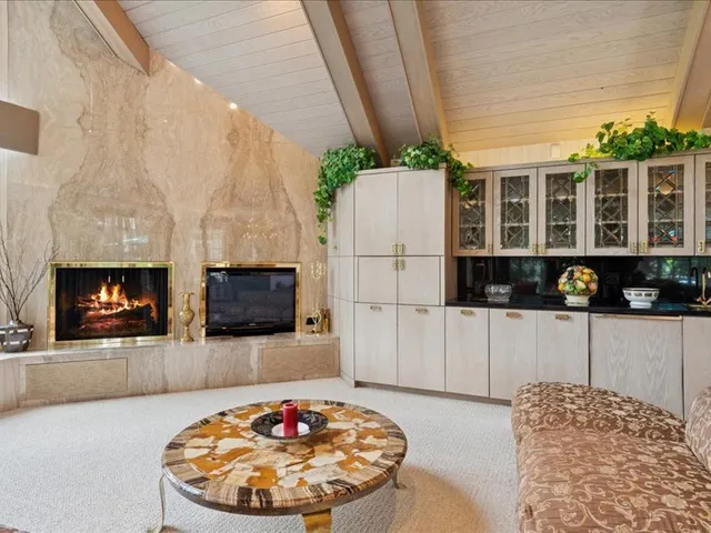 a view of a dining room with furniture a chandelier and wooden floor