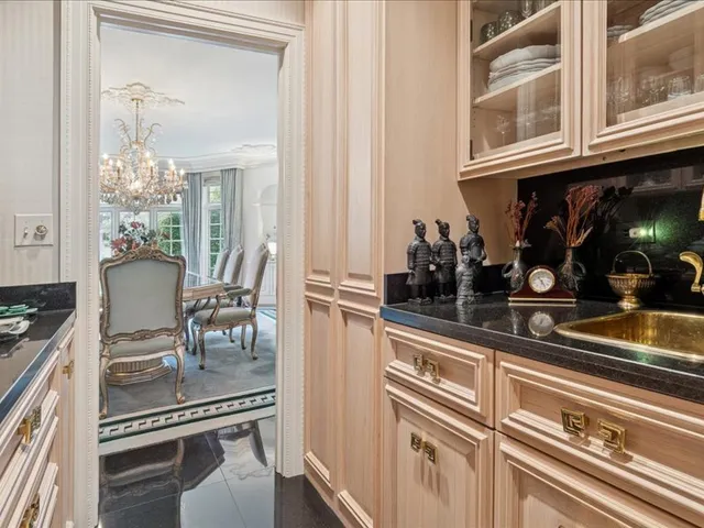 a view of a chair and table in backyard of the house