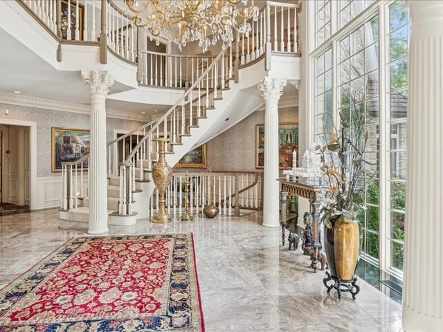 a living room with furniture a fireplace and a large window