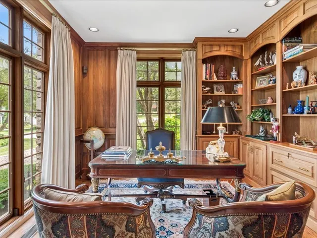 a kitchen with stainless steel appliances kitchen island granite countertop a refrigerator a stove a microwave oven with white cabinets and wooden floor