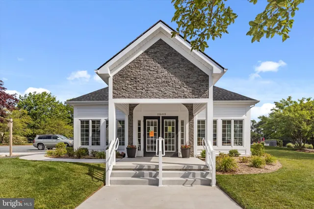 a front view of house with yard and outdoor seating
