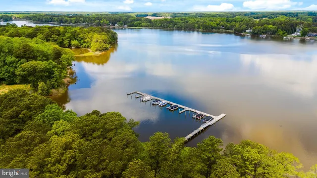 an aerial view of a house with a yard and lake view