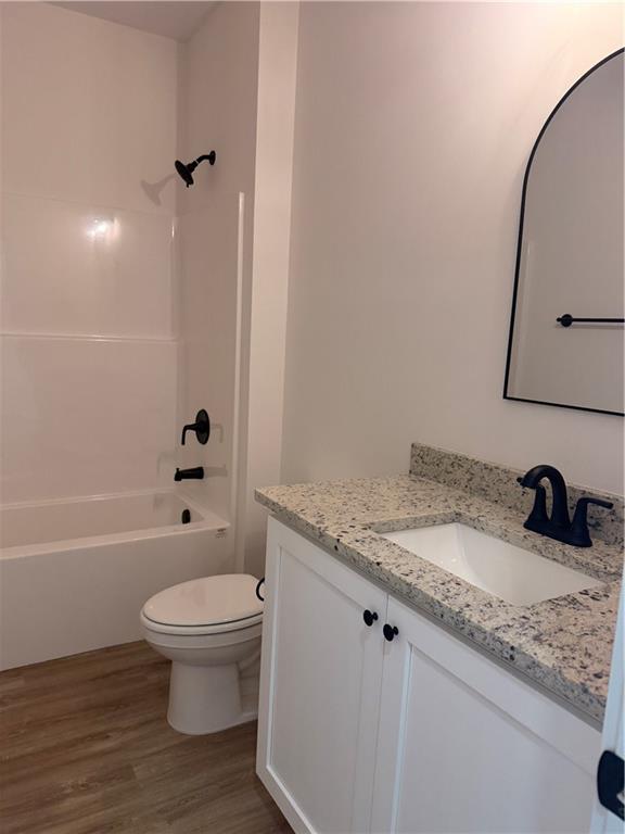 7213 King Road Valley, AL 36854 - Photo 19 of 20 White vanity with a speckled countertop, integrated sink, and matte black faucet