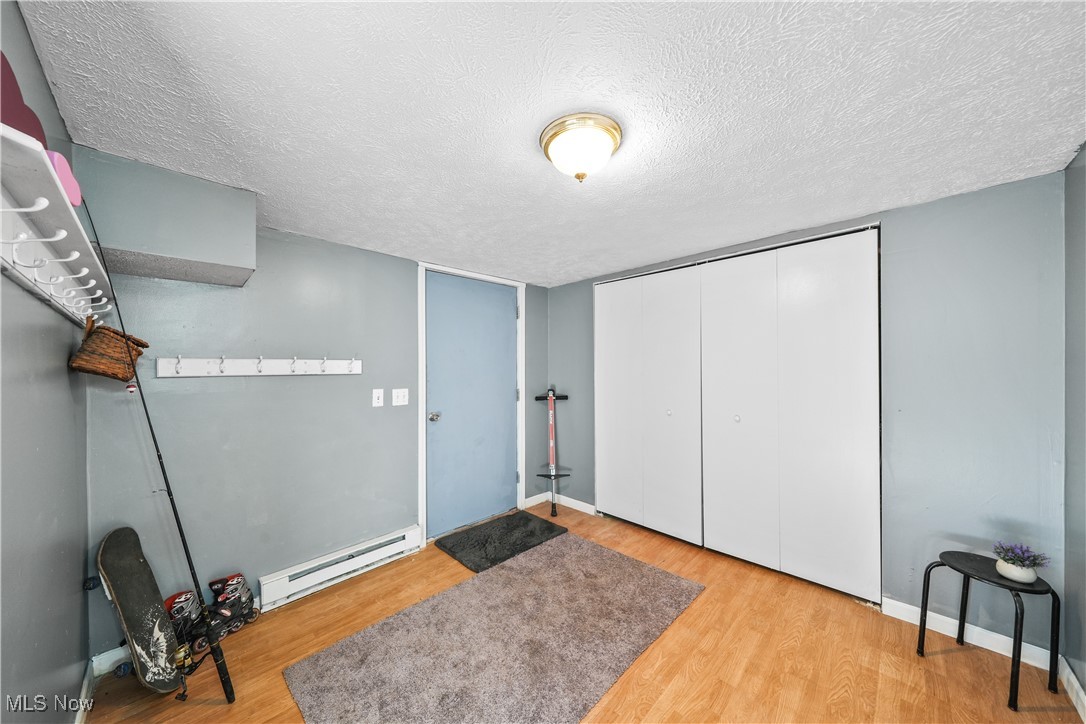 4947 Wayland Road Diamond, OH 44412 - Photo 23 of 43 Room featuring hardwood / wood-style flooring and a textured ceiling