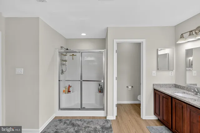 a view of kitchen with refrigerator and wooden floor