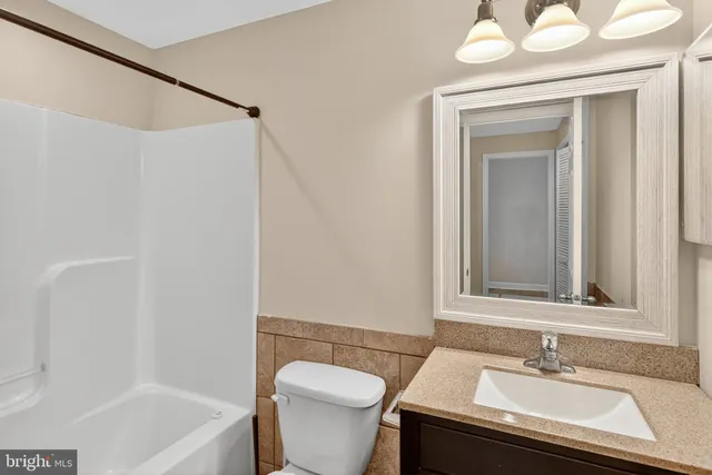 a bathroom with a sink a toilet and a bathtub