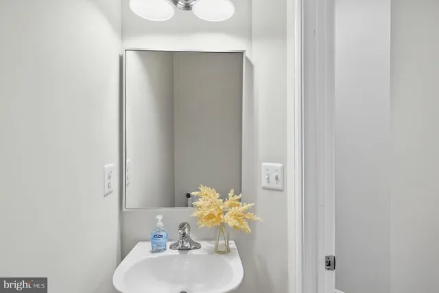 a bathroom with a sink mirror and toilet