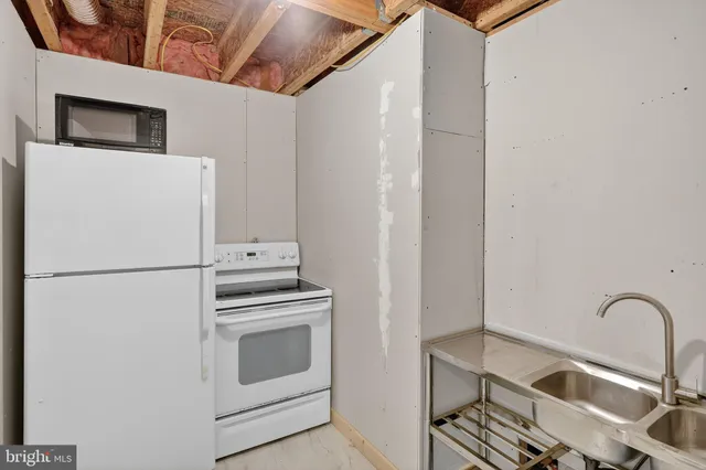 a white refrigerator freezer sitting inside of a kitchen