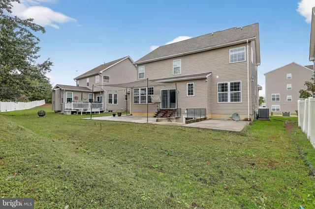 a front view of a house with a garden and plants
