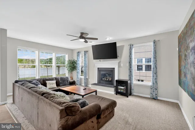 a living room with furniture flat screen tv and a fireplace