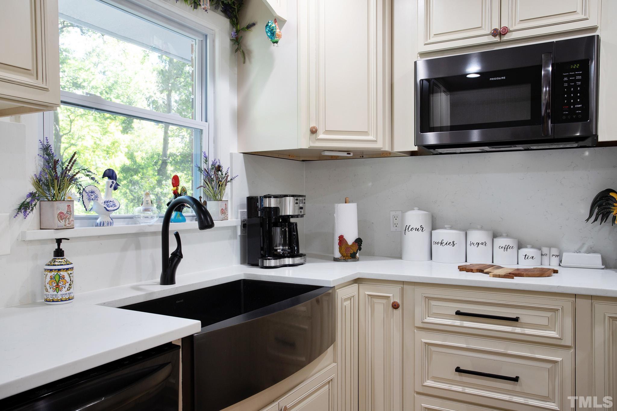 4719 Forestdale Road Raleigh, NC 27603 - Photo 16 of 28 a kitchen with a sink cabinets and a microwave