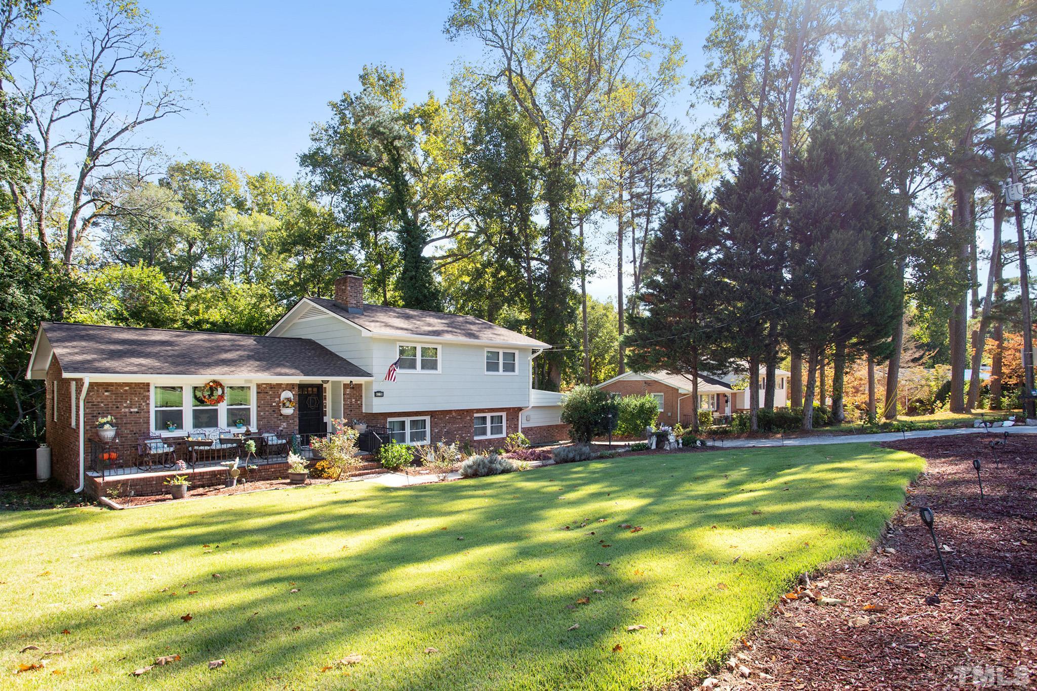4719 Forestdale Road Raleigh, NC 27603 - Photo 3 of 28 a swimming pool view with a seating space and a garden view