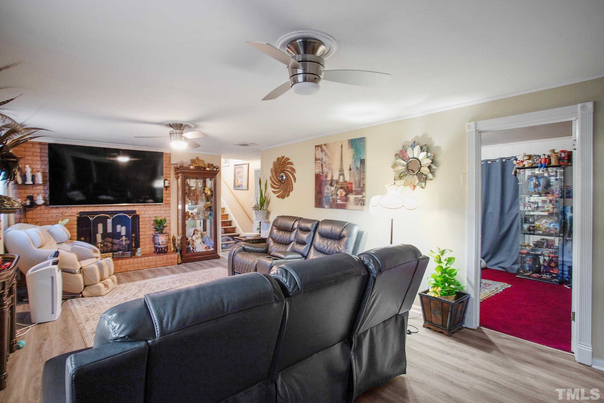 4719 Forestdale Road Raleigh, NC 27603 - Photo 21 of 28 a living room with furniture and a flat screen tv