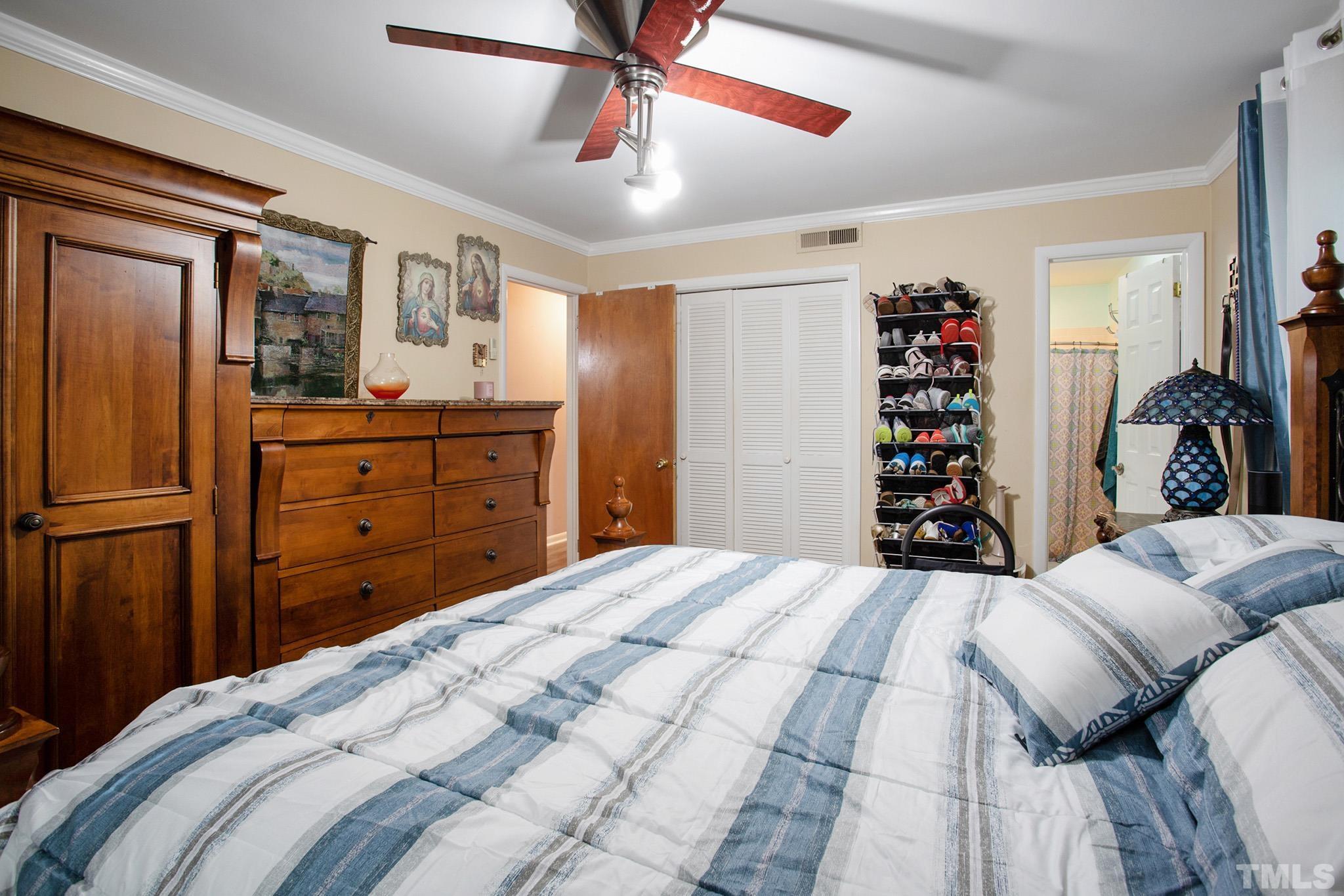 4719 Forestdale Road Raleigh, NC 27603 - Photo 23 of 28 a bedroom with a bed and a dresser