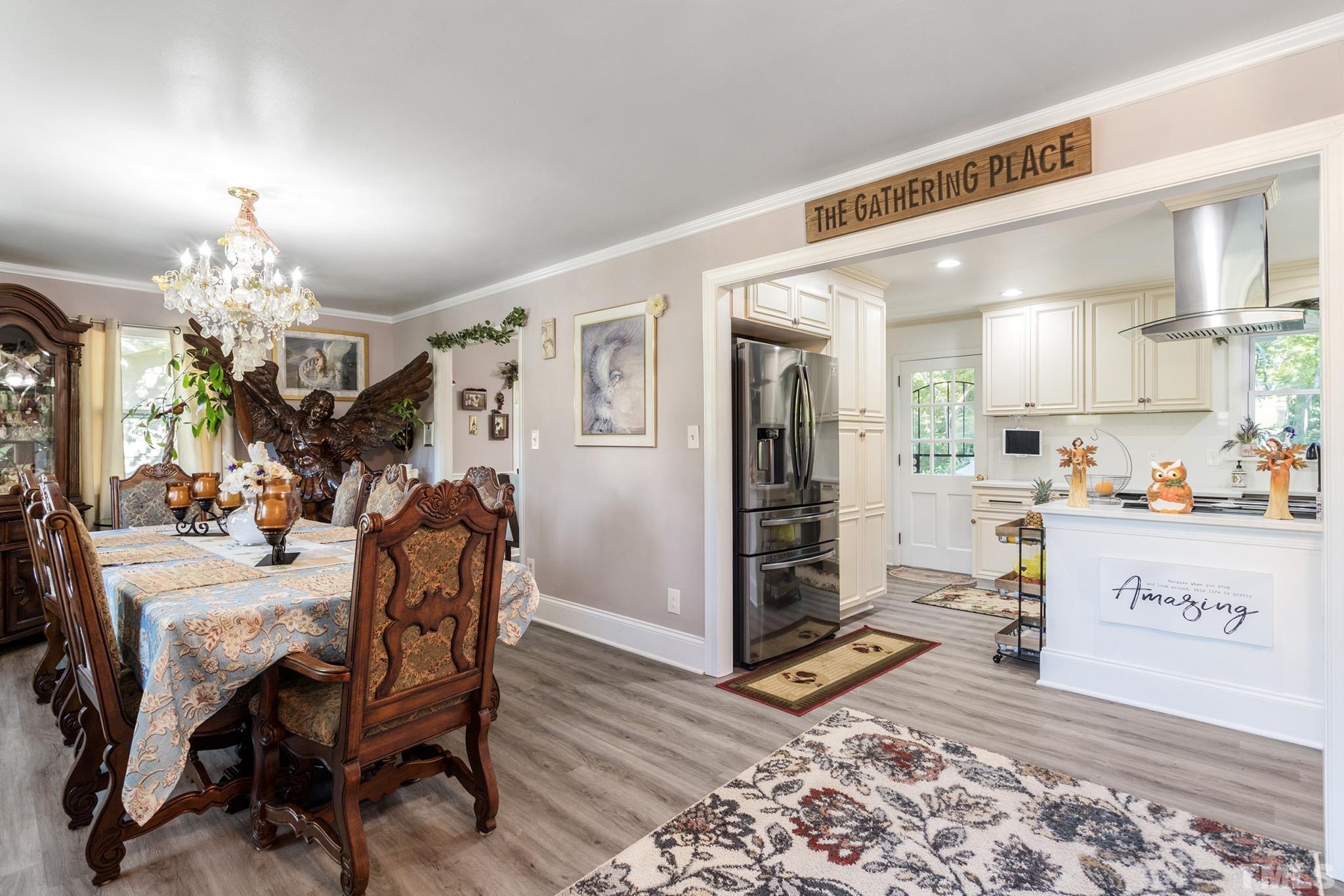 4719 Forestdale Road Raleigh, NC 27603 - Photo 5 of 28 a view of a dining room with furniture and chandelier
