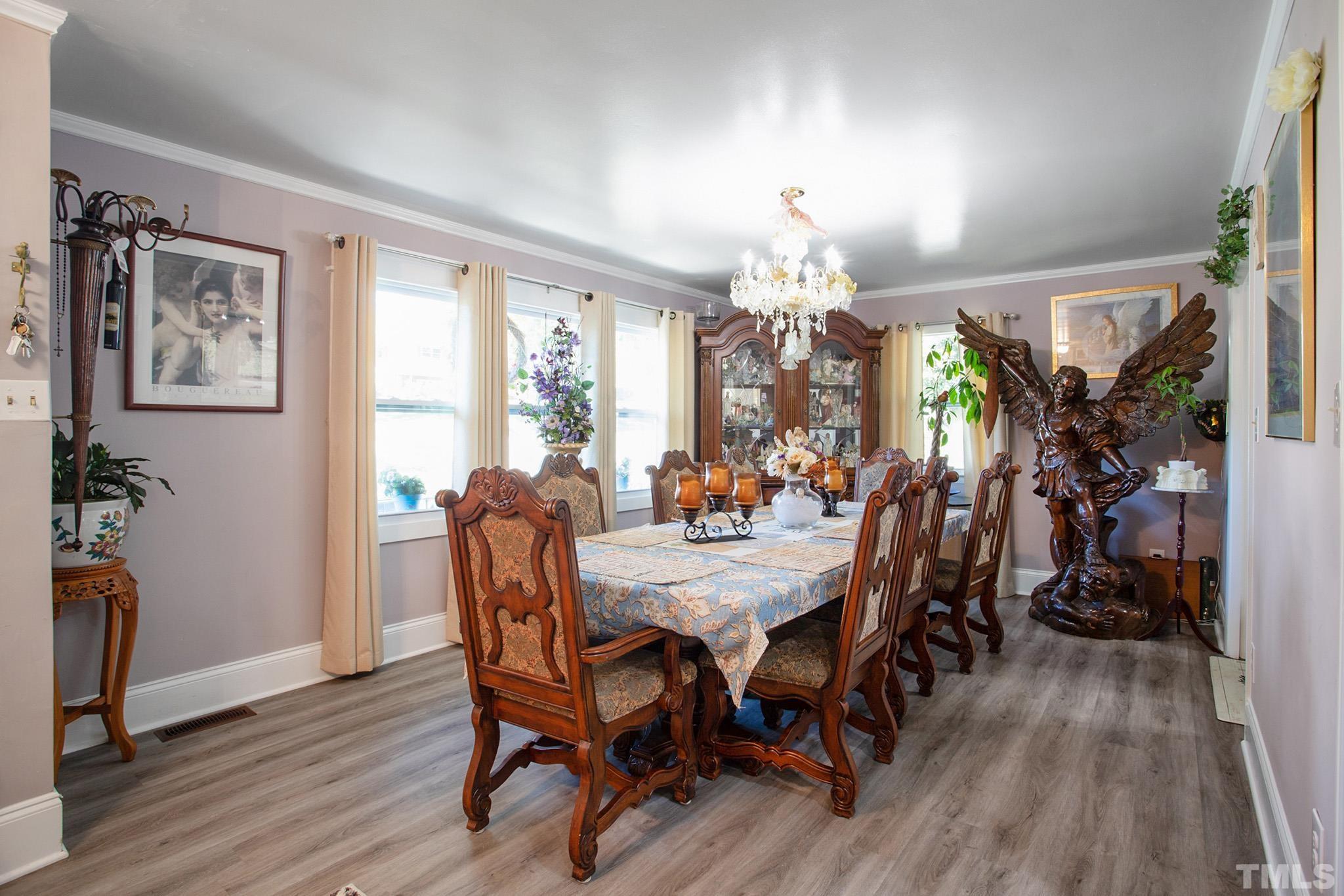 4719 Forestdale Road Raleigh, NC 27603 - Photo 6 of 28 a view of a dining room with furniture window and wooden floor