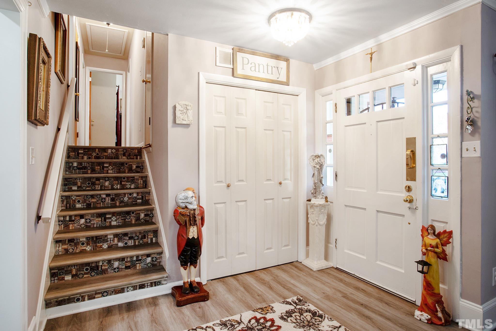 4719 Forestdale Road Raleigh, NC 27603 - Photo 9 of 28 a view of a hallway with entryway wooden floor and front door